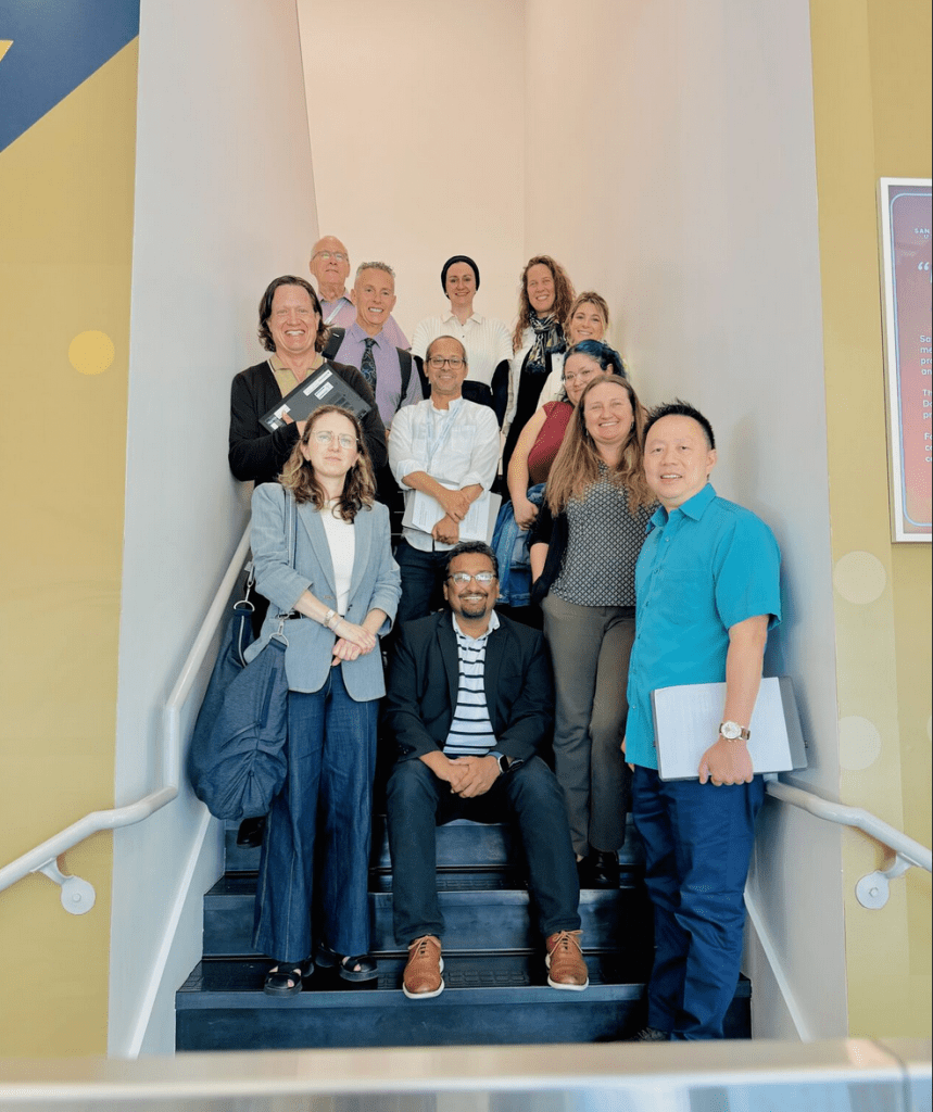 Image of 12 people standing on a staircase
